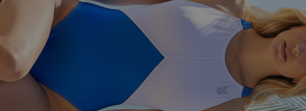 Woman in white and blue panelled one piece swimsuit
