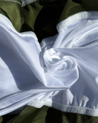 Close-up of white and khaki fabric with white stitching