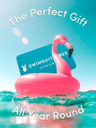 Pink flamingo inflatable pool float with a gift card on top, floating in water with text 'The Perfect Gift All Year Round' and 'Swimsuit Babes'.